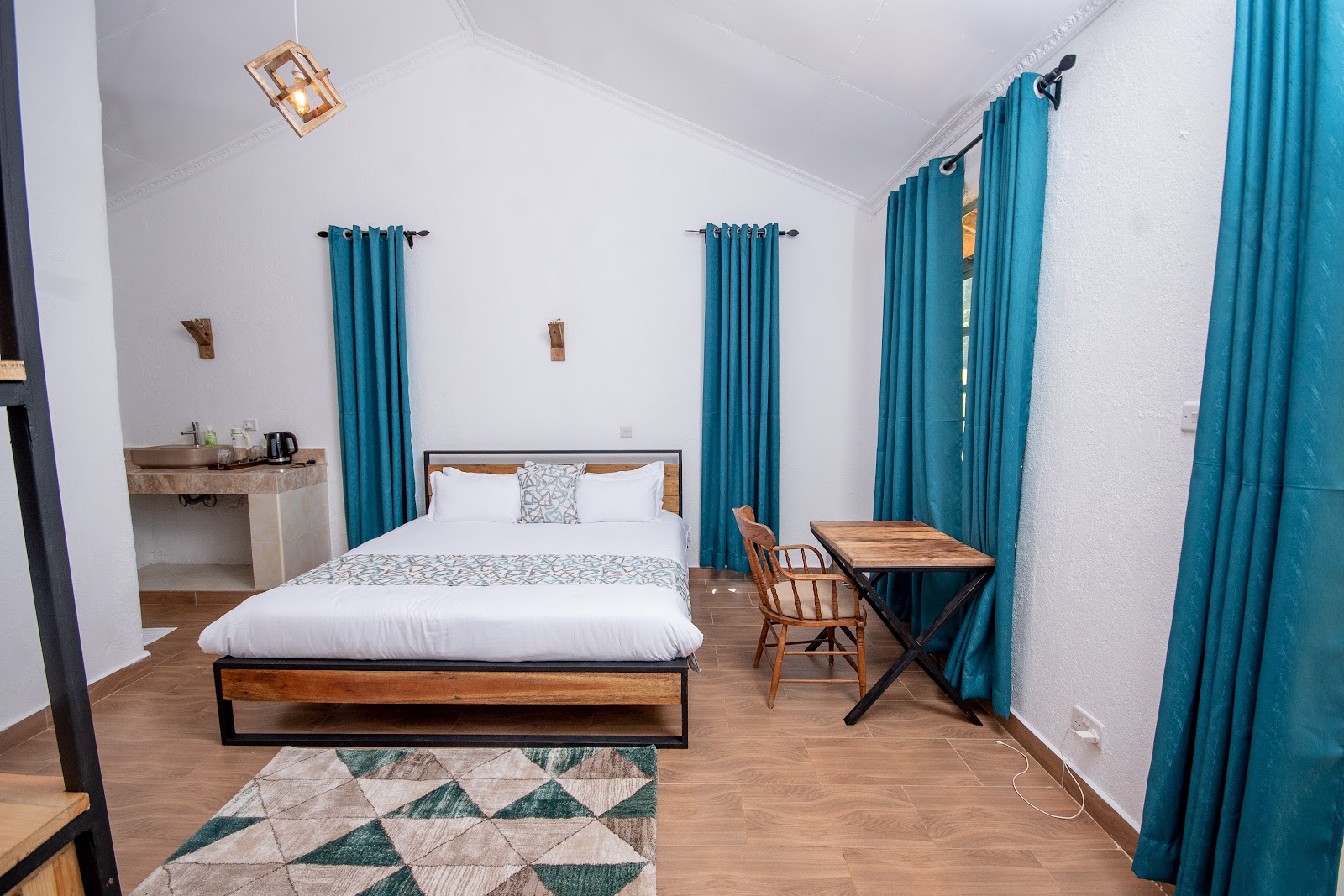 Boutique hotel guest room with warm neutral palette and woven wall art